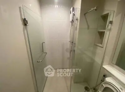 Modern bathroom with glass shower enclosure and sleek fixtures