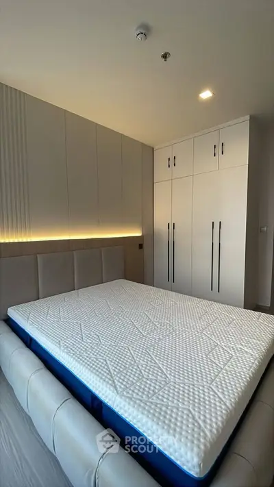 Modern bedroom with sleek built-in wardrobes and stylish lighting
