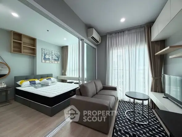 Modern studio apartment with cozy living area and stylish bedroom