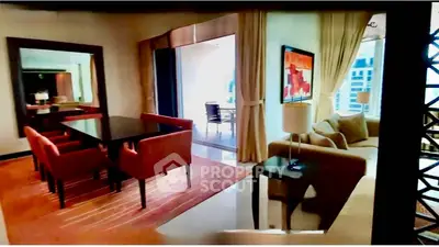 Luxurious living room with elegant dining area and balcony view in modern apartment.