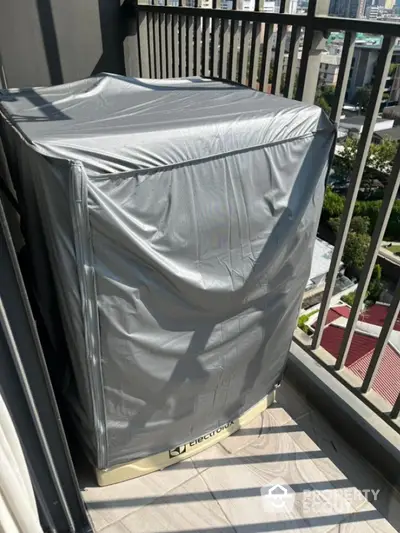 Covered appliance on a balcony with city view, perfect for urban living convenience.