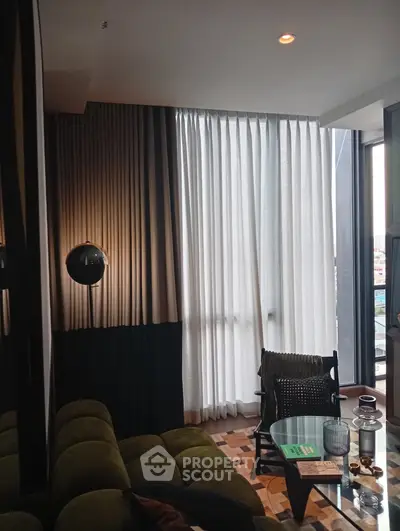 Stylish living room with modern decor and large window offering city views