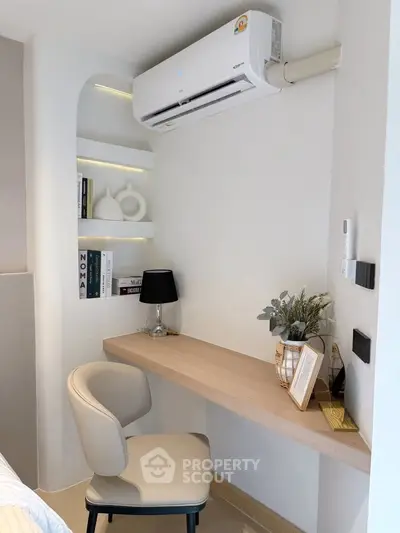 Modern study nook with built-in desk, chair, and air conditioning in a stylish apartment.