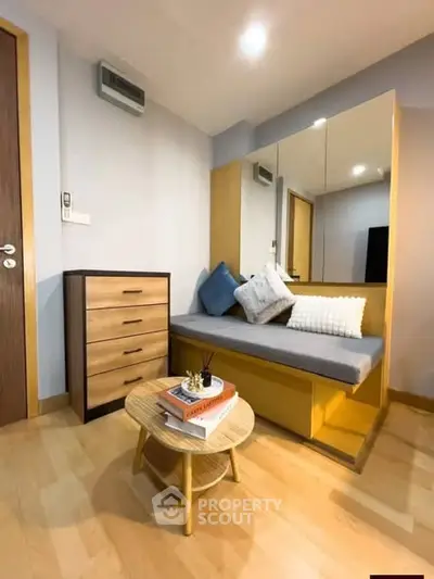 Cozy study nook with modern furniture and stylish decor in a well-lit room.