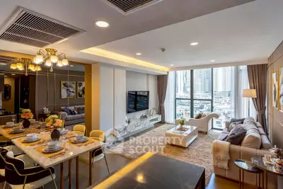 Luxurious open-plan living room with city view, elegant decor, and modern furnishings.