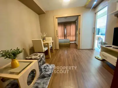 Modern apartment interior with cozy living room and bedroom, featuring wooden flooring and stylish decor.