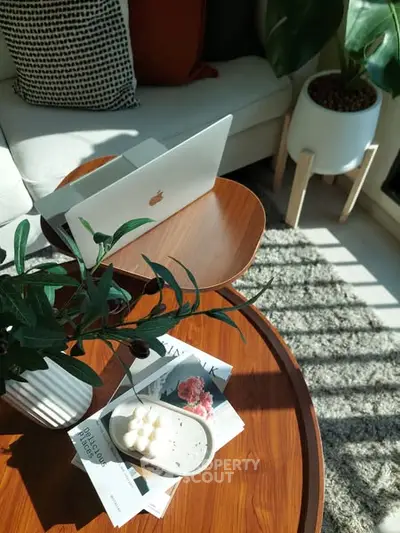 Cozy living room with modern decor and natural light, featuring a stylish coffee table and comfortable seating.