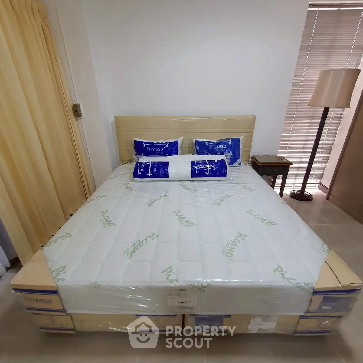 Cozy bedroom with neatly arranged bed and modern decor