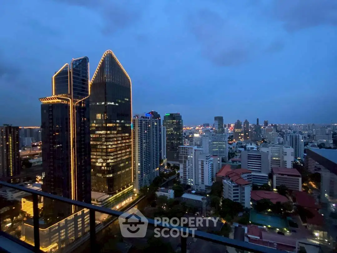 Stunning cityscape view from a high-rise balcony at dusk, showcasing illuminated skyscrapers and urban skyline.