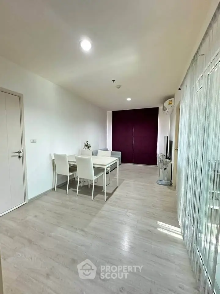 Spacious modern living room with dining area and sleek flooring