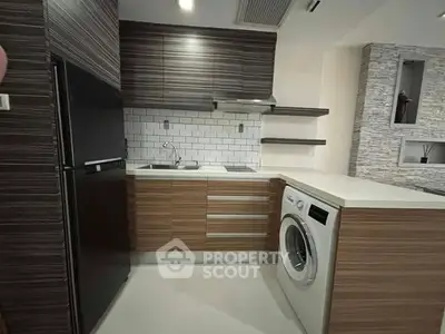 Modern kitchen with sleek cabinetry and built-in washing machine