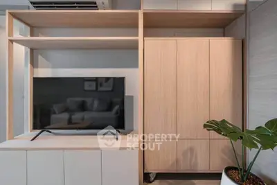 Modern living room with sleek TV unit and stylish wooden cabinetry