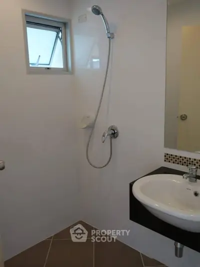 Modern bathroom with sleek shower and stylish sink design.