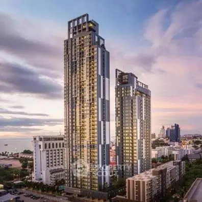 Stunning high-rise buildings with ocean view at sunset, perfect for luxury urban living.
