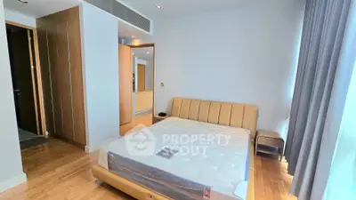 Spacious bedroom with modern design and large window for natural light
