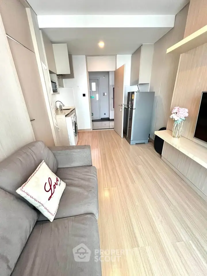 Modern living room with sleek kitchen and cozy sofa in stylish apartment