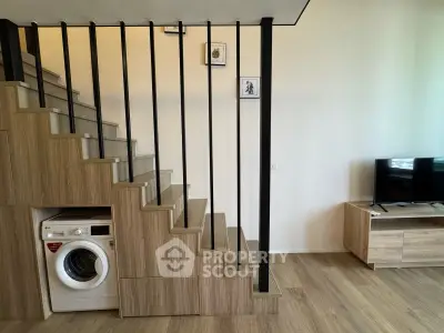 Modern duplex living room with wooden staircase and built-in washing machine