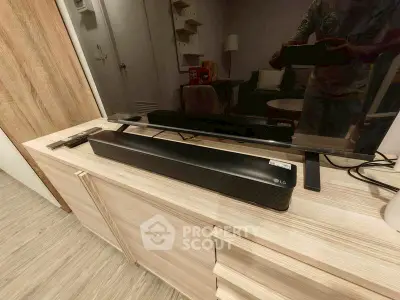 Modern living room with sleek soundbar and stylish wooden furniture