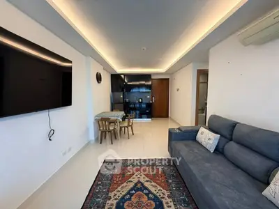 Modern living room with sleek furniture and open kitchen layout