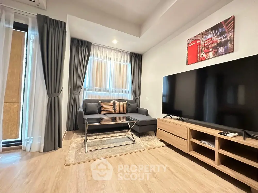 Modern living room with large TV and stylish decor in a cozy apartment