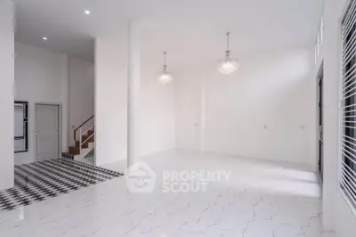 Spacious modern living room with elegant chandeliers and marble flooring