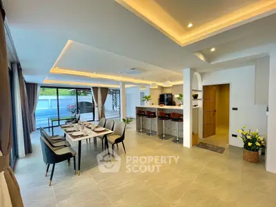 Spacious open-plan living and dining area with modern kitchen and stylish decor.