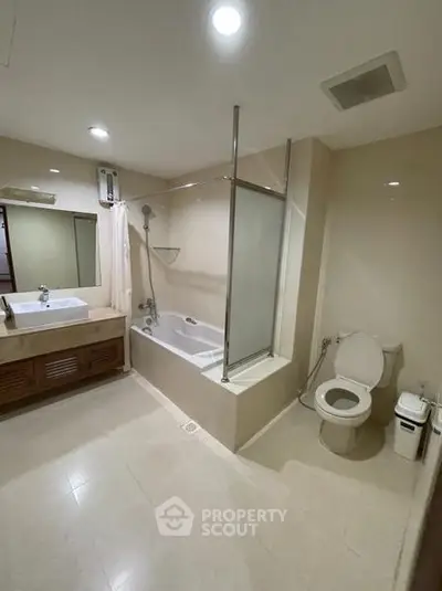 Spacious modern bathroom with bathtub and elegant fixtures in a contemporary home.