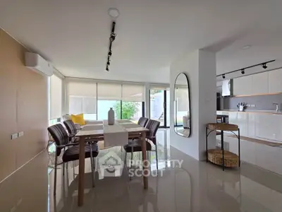 Modern dining area with sleek design and ample natural light in a contemporary home.