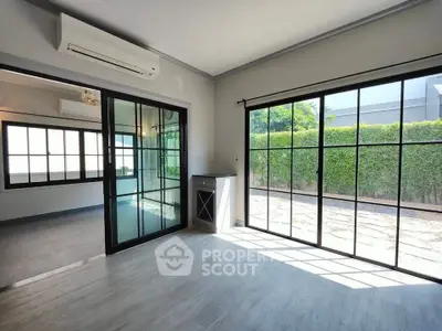 Bright modern living room with large windows and garden view