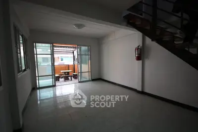 Spacious living room with large windows and balcony access in modern apartment.