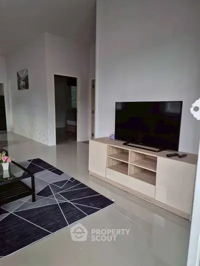 Spacious living room with modern TV setup and stylish decor