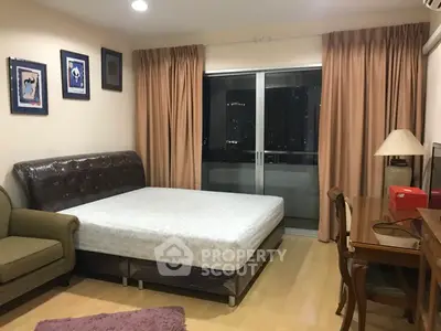 Spacious bedroom with city view, featuring a comfortable bed, elegant furniture, and large windows.
