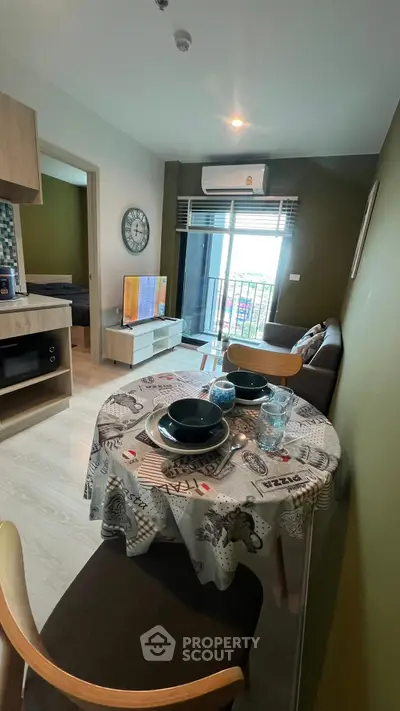 Chic modern living room with dining area and balcony view, perfect for urban lifestyle.