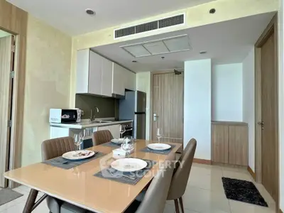 Modern kitchen with dining area featuring sleek cabinetry and contemporary appliances.
