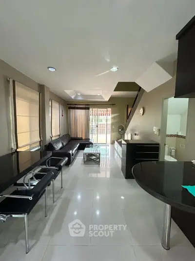 Spacious modern living room with sleek furniture and natural light