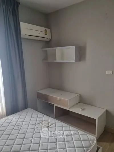 Cozy bedroom with air conditioning and modern furniture in a stylish apartment.