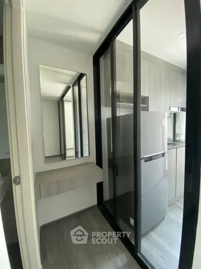 Modern compact kitchen with sleek design and glass sliding doors