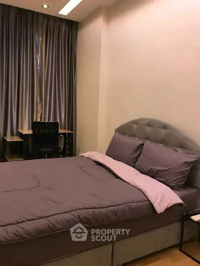 Cozy bedroom with plush bedding and study desk, ideal for comfort and productivity.