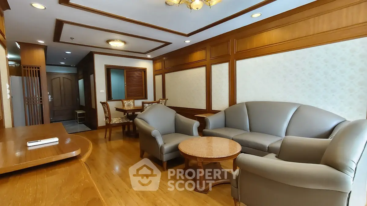 Elegant living room with classic wooden paneling and comfortable seating