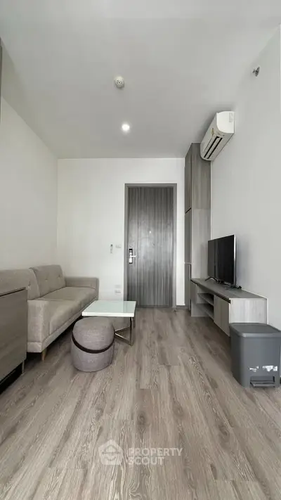 Modern living room with sleek furniture and wooden flooring