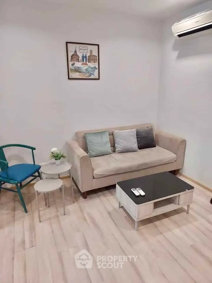 Cozy living room with modern decor and air conditioning, perfect for relaxation.