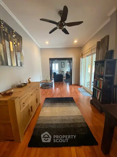 Spacious living room with modern decor and wooden flooring