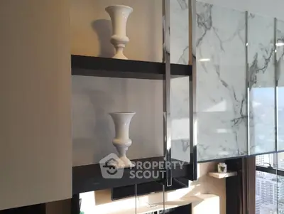 Modern interior with elegant shelving and marble accents in a luxury apartment.