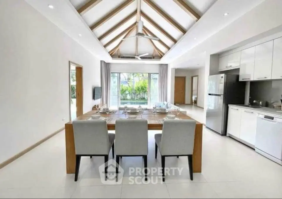 Spacious modern dining area with high ceiling and garden view
