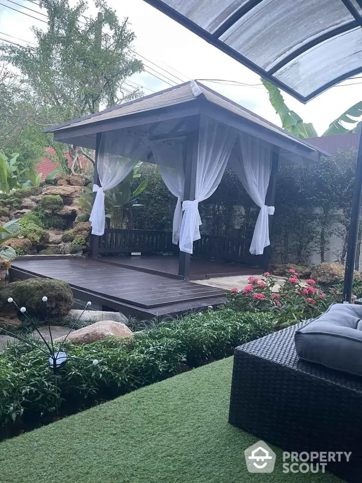 Charming garden with elegant gazebo and lush greenery, perfect for relaxation and outdoor gatherings.