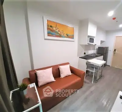 Modern living room with kitchenette and stylish decor in cozy apartment