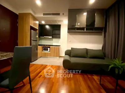 Modern apartment living room with sleek kitchen and cozy sofa