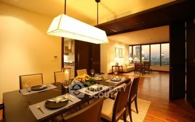 Luxurious dining and living area with elegant lighting and city view.