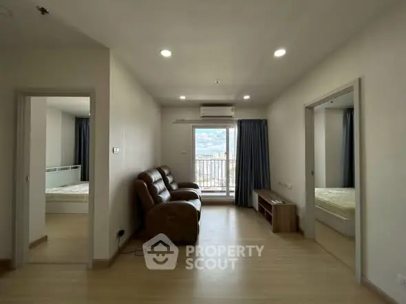 Spacious living room with balcony and mountain view in modern apartment