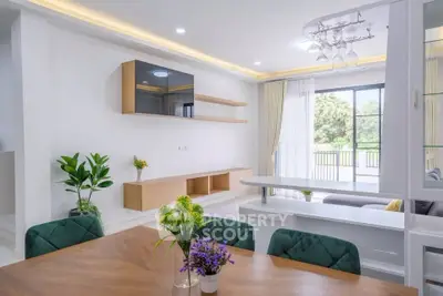 Spacious modern living room with elegant decor and large windows for natural light.